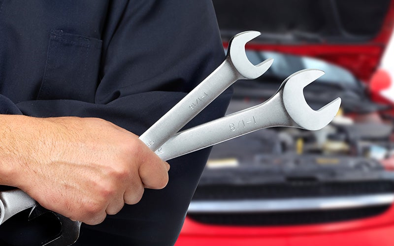 a person holding two wrenches